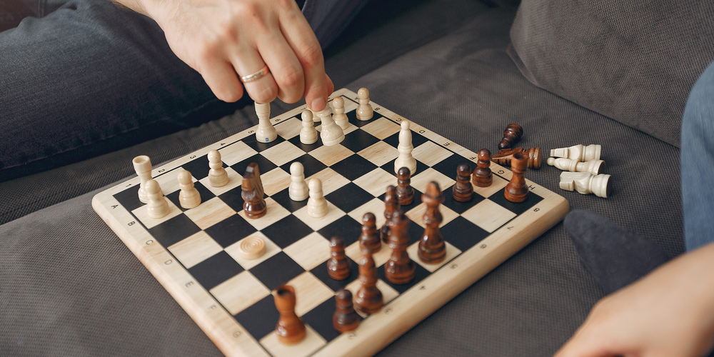 Father with little son. Family plaus in a chees. Peole at home.